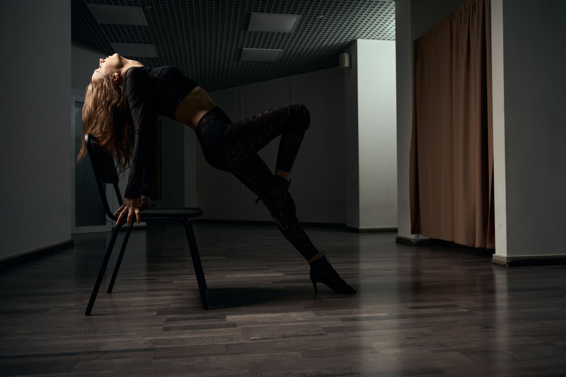 Female dancer performing high heels choreography with prop